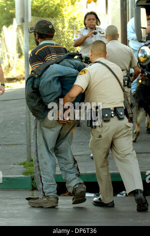 Oct 25, 2006; North Richmond, CA, USA; A Contra Costa County Sheriff's officer detains a man during a raid at Fifth Street and Market Avenue focusing on suspected drug trafficking that included Richmond police and the Contra Costa County Sheriff's Office in North Richmond, California, on Wednesday, Oct. 25, 2006. Mandatory Credit: Photo by Mark DuFrene/Contra Costa Times/ZUMA Press Stock Photo