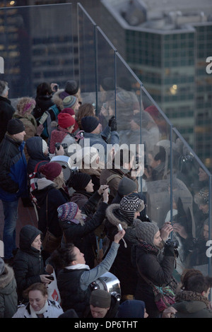 Crowds of tourists take int he New York views from the Rockefeller Centre center rooftop at dusk Stock Photo
