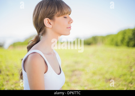 Peaceful young woman relaxing outside Stock Photo