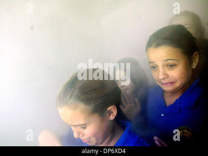 Oct 26, 2006; Stuart, FL, USA; Pine School 4th graders Sofia Alvarez, 9, left,  Sarah Banks, 10, middle, and Andrea Adler, 9, attempt to find their way out through heavy smoke in a mock house fire simulated in the Red Cross Disaster Education Simulator (DES) which recreates conditions encountered during a house fire.   The American Red Cross Martin County Chapter: presented disaste Stock Photo