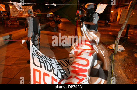 Oct 29, 2006; Oaxaca City, MEXICO; Federal police tear down signs from the Popular Assembly of the People of Oaxaca, APPO, left Sunday Oct. 29, 2006 in Oaxaca City, Oaxaca, Mexico. Mexican President Vicente Fox ordered federal police to take control of the city that has been ruled for the past five months by the Popular Assembly of the People of Oaxaca. Mandatory Credit: Photo by E Stock Photo