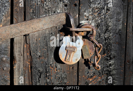 two padlocks on old garage door, norfolk, england Stock Photo