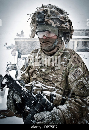 US Army Pfc. Dewey So covered in snow during a storm while on patrol January 15, 2012 in the village of Marzak, Paktika province, Afghanistan. Stock Photo