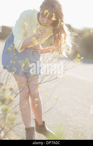 Peaceful hipster girl smelling flowers Stock Photo