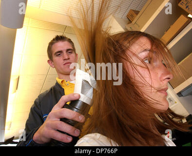 Nov 02, 2006 - Salt Lake City, Utah, USA - University of Utah researcher, DALE CLAYTON, has created a hairdryer-like device to kill lice, as opposed to the traditional shampoo treatment.  Grad students, MATT JACOBSEN and JENNIFER HUTCHENS demonstrate how it lifts the hair, blows warm air and rids the head of lice.  The head louse (Pediculus humanus capitis) is an obligate, ectopara Stock Photo