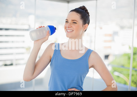 Happy fit woman holding plastic flask Stock Photo