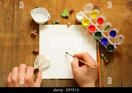 painting set - brushes, paints (gouache) on old wooden table Stock Photo