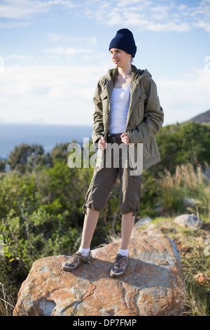 Woman standing on a rock wearing a beanie hat Stock Photo