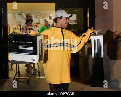 Nov 17, 2006; West Palm Beach, FL, USA; Andres Erazo, 19, of Miami, walks out of the Walmart at Military Trail and Belvedere after purchasing two Playstation 3's.  Erazo and his mother were the first to purchase the system at this Walmart.  He planned to keep one and sell the other.  'Feels great man, 40 something hours later, I haven't slept, called off work, missed school and I a Stock Photo