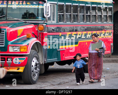 Mar 24, 2006 - Santiago Atitlan, Solola, Guatemala - People in the bus station where former American school buses now serve as  Guatemala's local and long distance buses, some with old markings from their past lives in America, still intact, contrast with local culture at the bus station in the city of Santiago Atitlan, Guatemala (Credit Image: © David H. Wells/ZUMAPRESS.com) Stock Photo