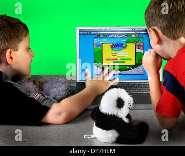 Nov 14, 2006; West Palm Beach, FL, USA; (L-R) Jake Reinhart 9 and his brother Brian Reinhart, 6 logging onto Webkinz.com.  Mandatory Credit: Photo by Jaime Kujala/Palm Beach Post/ZUMA Press. (©) Copyright 2006 by Palm Beach Post Stock Photo