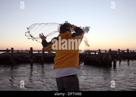 Nov 17, 2006; Venice, LA, USA; A fisherman throws out a cast net to catch  bait in the early morning light. Mandatory Credit: Photo by Marianna Day  Massey/ZUMA Press. (©) Copyright 2006