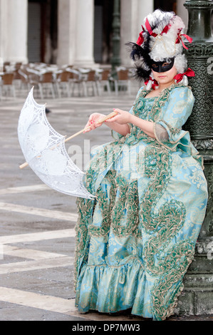 Venice carnival participant wearing elaborate costume and mask Stock Photo