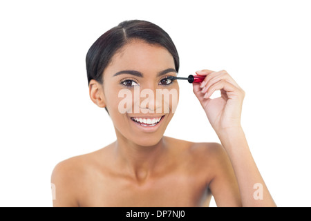 Pretty natural model applying mascara Stock Photo