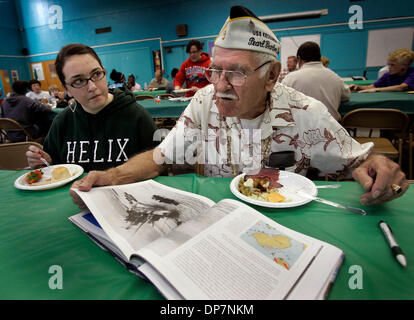 Nov 14, 2006; San Diego, CA, USA; Helix High School 11 grade student ALISON DREYLINGER, left, looks on as DORIAN BOYD of Lakeside, right, a Pear Harbor Survivor of World War II looks through the book, Pearl Harbor, The Day of Infamy Ð An Illustrated History at lunch during the annual Veterans Appreciation Day at the school where veterans visited classes, talked with students and we Stock Photo