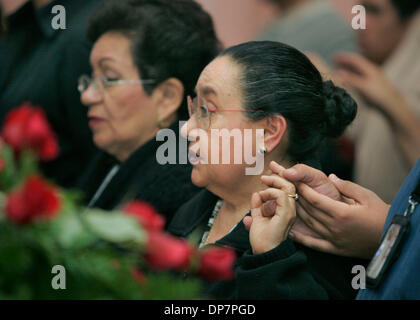 Nov 24, 2006; Tijuana, MEXICO; GEVOVEVA VILLALON hold hands with son RAMON BLANCO VILLALON during the funeral for her husband Jesus Blancornelas at Iglesia (church) Santa Teresa de Avila in central Tijuana this afternoon. Mandatory Credit: Photo by Charlie Neuman/SDU-T/ZUMA Press. (©) Copyright 2006 by SDU-T Stock Photo