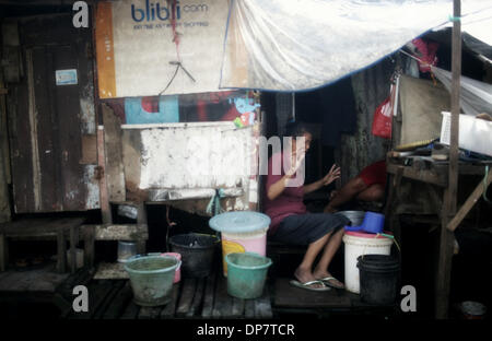 Jan 7, 2014 - South Jakarta, Indonesia - Two Woman in one of the dozens slums located in Jakarta city, Indonesia. Because of extreme poverty in Western parts of Indonesia such as Java, Ambon and Papua, many poor move to Jakarta and settle in self-build slums that have serious problems with water sanitation, hygiene and electricity. Indonesia has some of the world's worst sanitation and wide spread diseases are not uncommon in the slums.Apart from that the people live continuously on the brink of eviction because the slums are self-build settlements and thus illegal by Indonesian law. (Credit I Stock Photo