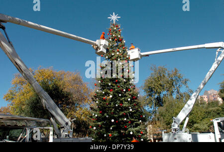 Nov 29, 2006; Concord, CA, USA; Darren Perry, left, and Rich Hartmann, right, work from 55-foot booms Wednesday, Nov. 29, 2006, to decorate the city Christmas tree in Todos Santos Plaza in Concord. This year's city tree is a 50-foot fir from the Mt. Shasta area.  Both Perry and Hartmann work for the Concord Parks department tree crew. Mandatory Credit: Photo by Bob Pepping/Contra C Stock Photo