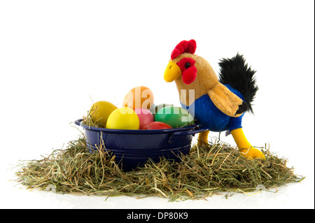 Blue bucket with straw and colorful painted easter eggs and chicken Stock Photo