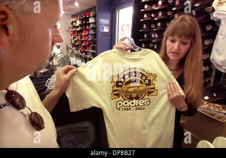 Published 09/25/2003, B-4:1; UTS1762306)At the Padres Store at Qualcomm  Stadium ERICKA DAGUIA (cq) buttons up Padres jersey on daughter MIDORIE  (cq), 2. They live in San Diego. They bought the jersey. U/T