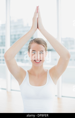 Smiling fit woman doing yoga session Stock Photo