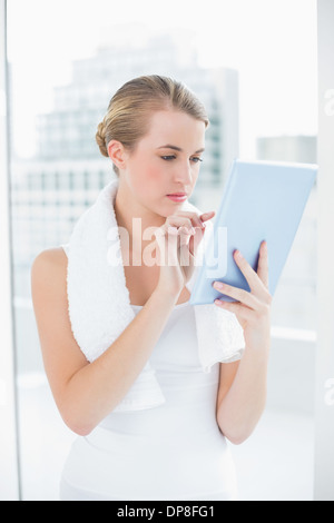 Focused sporty woman using tablet pc Stock Photo
