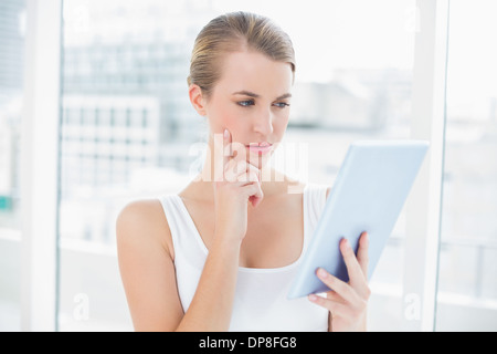 Focused sporty woman using tablet computer Stock Photo