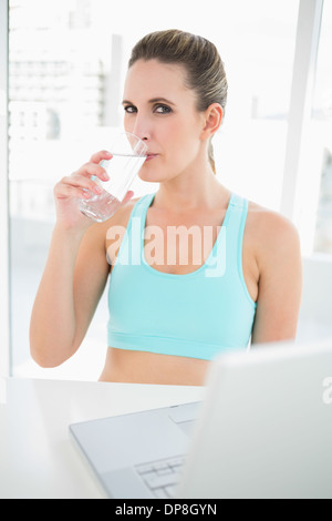 Fit woman in sportswear drinking water Stock Photo