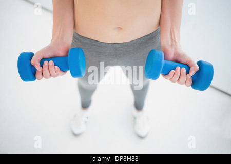 Woman working out with dumbbells Stock Photo