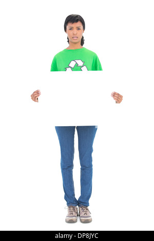 Frowning black haired ecologist holding a white panel in front of her Stock Photo