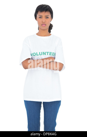 Depressed black haired volunteer posing with crossed arms Stock Photo