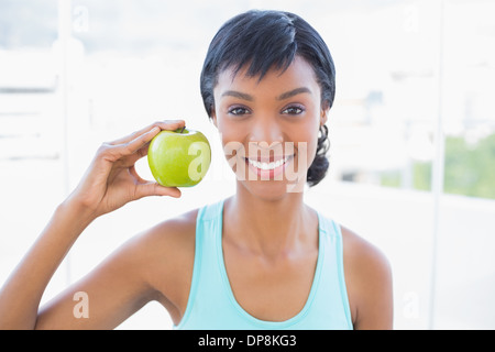 Attractive black haired woman holding an apple Stock Photo