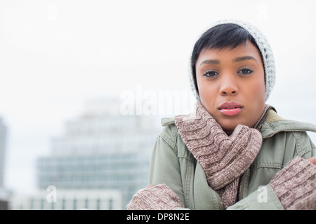 Cute young model in winter clothes shivering Stock Photo