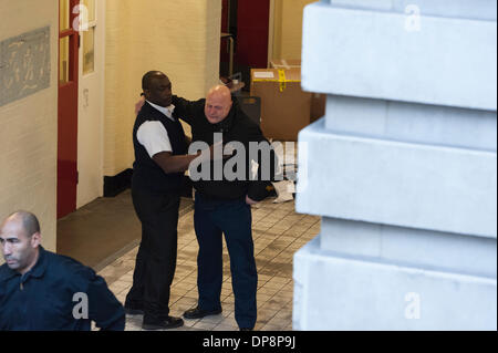 London, UK. 9th January, 2014. Two firefighters console one another as they leave Clerkenwell Fire Station for the last time. The closure is part of a controversial cost-cutting policy instigated by the Mayor of London, Boris Johnson. Credit:  Lee Thomas/Alamy Live News Stock Photo