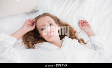 Dreamy pretty woman lying on her bed Stock Photo