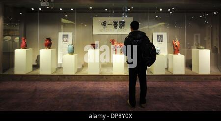 Zhengzhou, China's Henan Province. 9th Jan, 2014. A visitor looks at porcelain works at an exhibition on the theme of Buddhism in Zhengzhou, capital of central China's Henan Province, Jan. 9, 2014. Credit:  Li An/Xinhua/Alamy Live News Stock Photo