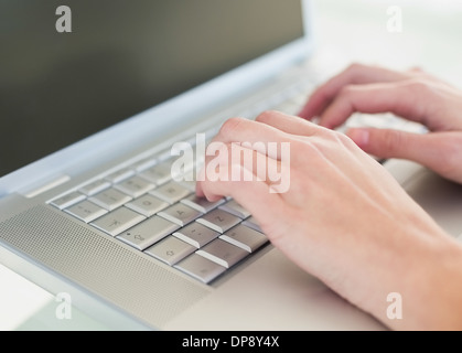 Close up of hands using a laptop Stock Photo