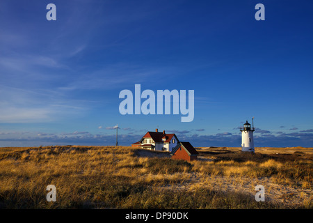 Reclusiveness and the Setting Sun Along the Cape Cod National Seashore at Race Point Lighthouse in Provincetown Massachusetts Stock Photo