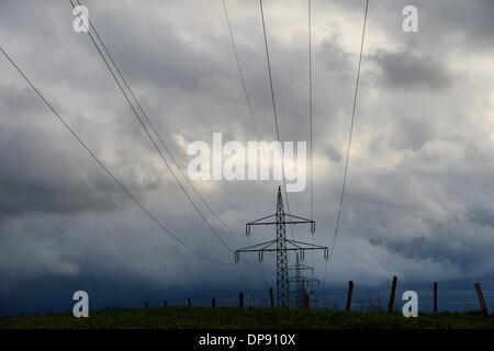 Electrical towers with spectacular clouds in Germany, 8.January 2014. Photo: Frank May Stock Photo