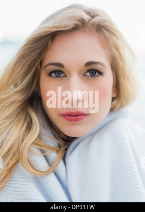 Lovely blonde woman covering herself in a blanket Stock Photo