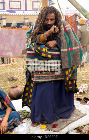 Sadhu (holy man) with dreadlocks carrying out a standing penance at the Ganga Sagar Mela, Sagar Island, West Bengal, India Stock Photo