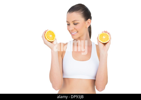 Fit woman holding slices of orange Stock Photo