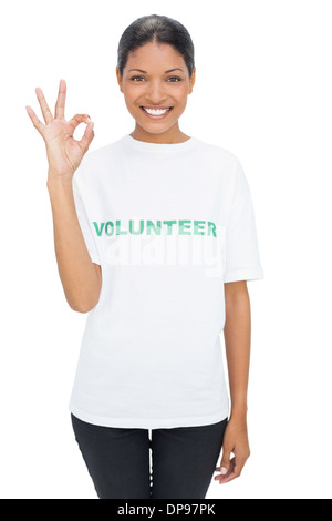 Smiling model wearing volunteer tshirt making okay gesture Stock Photo