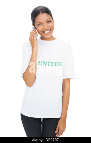 Happy model wearing volunteer tshirt having a phone call Stock Photo
