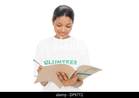 Cheerful model wearing volunteer tshirt writing Stock Photo