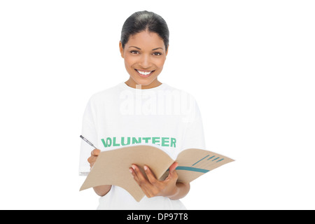 Smiling model wearing volunteer tshirt writing Stock Photo