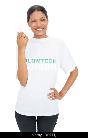 Happy model wearing volunteer tshirt holding light bulb Stock Photo
