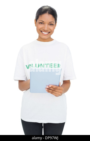 Happy model wearing volunteer tshirt holding tablet Stock Photo