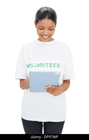 Smiling model wearing volunteer tshirt holding tablet Stock Photo