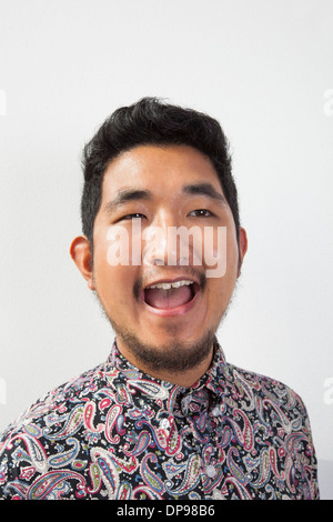 Happy young man looking away against white background Stock Photo